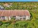 Ground level view of condo building with screened lanai at 4655 Tower Hill Ln # 2412, Sarasota, FL 34238