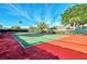 Community tennis court with red and green surface at 4655 Tower Hill Ln # 2412, Sarasota, FL 34238