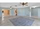 Open living room with neutral decor and access to other rooms at 470 Leger Dr, Nokomis, FL 34275