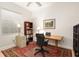 Home office with wooden desk and built-in bookcase at 4964 Bella Terra Dr, Venice, FL 34293