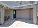 Gray house exterior with white garage door and green front door at 528 Forest Way, Longboat Key, FL 34228