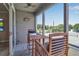 Relaxing screened porch with outdoor seating overlooking tennis courts at 528 Forest Way, Longboat Key, FL 34228