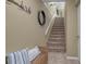 Staircase with carpet runner and wicker bench at 528 Forest Way, Longboat Key, FL 34228