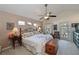 Main bedroom with king-size bed, private balcony access, and ceiling fan at 5524 River Sound Ter, Bradenton, FL 34208