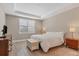 Serene bedroom with a plush bed, wooden dresser, and window shutters at 5716 Bay Pine Way, Sarasota, FL 34238