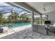 Spacious pool area with covered patio and seating at 5716 Bay Pine Way, Sarasota, FL 34238