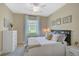 Comfortable bedroom with a queen bed, dresser, and window at 5729 Long Shore Loop, Sarasota, FL 34238