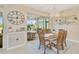 Bright dining room with wooden table and chairs, and access to a patio at 5729 Long Shore Loop, Sarasota, FL 34238