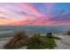 Serene waterfront view with beach grasses in the foreground at 585 Gunwale Ln, Longboat Key, FL 34228