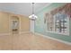 Bright dining room with tile floors, chandelier, and two-toned walls at 6207 Warbler Ln, Lakewood Ranch, FL 34202