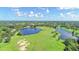 Aerial view of a lush golf course with lakes at 7615 Windward Cv, Lakewood Ranch, FL 34202