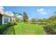 Landscaped backyard with a scenic lake view and lush greenery at 7615 Windward Cv, Lakewood Ranch, FL 34202