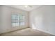 Spacious bedroom with plush carpeting and large window with shutters at 7615 Windward Cv, Lakewood Ranch, FL 34202