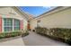 Inviting home exterior with a brick walkway and lush landscaping at 7615 Windward Cv, Lakewood Ranch, FL 34202