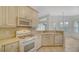 Kitchen with white cabinets, gas range and built-in microwave at 7615 Windward Cv, Lakewood Ranch, FL 34202