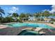 Relaxing community pool and spa with surrounding palm trees at 7615 Windward Cv, Lakewood Ranch, FL 34202