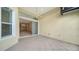 Small side patio with sliding glass doors leading to interior at 7615 Windward Cv, Lakewood Ranch, FL 34202