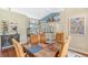 Bright dining room with hardwood floors and seating for six at 8033 Fairhaven Gln, University Park, FL 34201