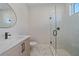 Modern bathroom with a walk-in shower, marble flooring, and floating vanity at 8387 Windbound Ct, Sarasota, FL 34240