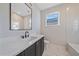 Bathroom boasting a dark vanity and marble flooring at 8387 Windbound Ct, Sarasota, FL 34240