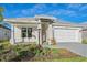 Single-story home with a gray roof and landscaping at 8387 Windbound Ct, Sarasota, FL 34240