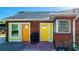 Brick home with two yellow doors and a grill at 847 Myrtle St, Sarasota, FL 34234