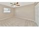 Bedroom with ceiling fan, window and neutral colored carpet at 3145 Kingston St, Port Charlotte, FL 33952