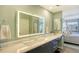 Modern bathroom with double vanity and illuminated mirror at 1095 Gulf Of Mexico Dr # 502, Longboat Key, FL 34228