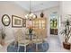 Elegant dining room with glass-top table and chandelier at 12240 Thornhill Ct, Lakewood Ranch, FL 34202