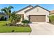 Single-story house with a two-car garage and well-maintained landscaping at 12640 Coastal Breeze Way, Bradenton, FL 34211