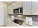 Modern kitchenette with granite countertops and stainless steel appliances at 13051 Utopia Loop, Bradenton, FL 34211