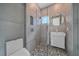 Contemporary bathroom with a walk-in shower, pebble flooring, and a floating vanity at 1720 Alderman St, Sarasota, FL 34236