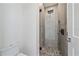 Clean bathroom with a toilet and a walk-in shower with pebble floor at 1720 Alderman St, Sarasota, FL 34236