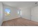 Spacious bedroom with hardwood floors and two windows at 1720 Alderman St, Sarasota, FL 34236