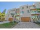 Modern three-story townhouses with attached garages and paved driveways at 1720 Alderman St, Sarasota, FL 34236