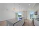 Open concept kitchen with island, stainless steel appliances, and hardwood floors at 1720 Alderman St, Sarasota, FL 34236