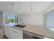 Kitchen island with a large sink and modern pendant lighting at 1720 Alderman St, Sarasota, FL 34236