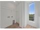 Laundry room with overhead shelving and a window offering natural light at 1720 Alderman St, Sarasota, FL 34236