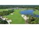Aerial view of a golf course with clubhouse and water features at 19439 Beacon Park Pl, Bradenton, FL 34202