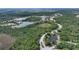 Aerial view of luxurious homes and a pristine lake in a new community at 19439 Beacon Park Pl, Bradenton, FL 34202