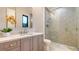 Modern bathroom with a walk-in shower, floating vanity, and pebble stone flooring at 19439 Beacon Park Pl, Bradenton, FL 34202