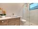 Contemporary bathroom with a shower, floating vanity, and textured wall tiles at 19439 Beacon Park Pl, Bradenton, FL 34202