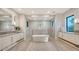 Spa-like bathroom with freestanding tub, large walk-in shower, and dual vanities at 19439 Beacon Park Pl, Bradenton, FL 34202