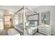 Elegant main bedroom with a four-poster bed, ensuite bathroom access, and ample natural light at 19439 Beacon Park Pl, Bradenton, FL 34202