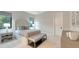 Bright bedroom with a comfortable bed, nightstands, and an attached bench at 19439 Beacon Park Pl, Bradenton, FL 34202