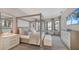 Main bedroom with a four-poster bed, water views, and ample closet space at 19439 Beacon Park Pl, Bradenton, FL 34202