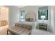 Serene bedroom with attached bathroom and plenty of natural light at 19439 Beacon Park Pl, Bradenton, FL 34202