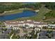 Aerial view of clubhouse with parking and landscaping at 19439 Beacon Park Pl, Bradenton, FL 34202