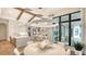 Bright dining area with round table, modern lighting, and access to outdoor patio at 19439 Beacon Park Pl, Bradenton, FL 34202