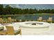 Relaxing fire pit area with wicker chairs and golf course views at 19439 Beacon Park Pl, Bradenton, FL 34202